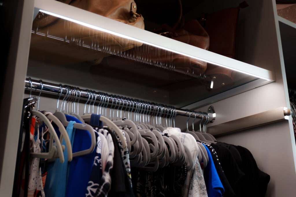 photo of hanging clothes with lighting above