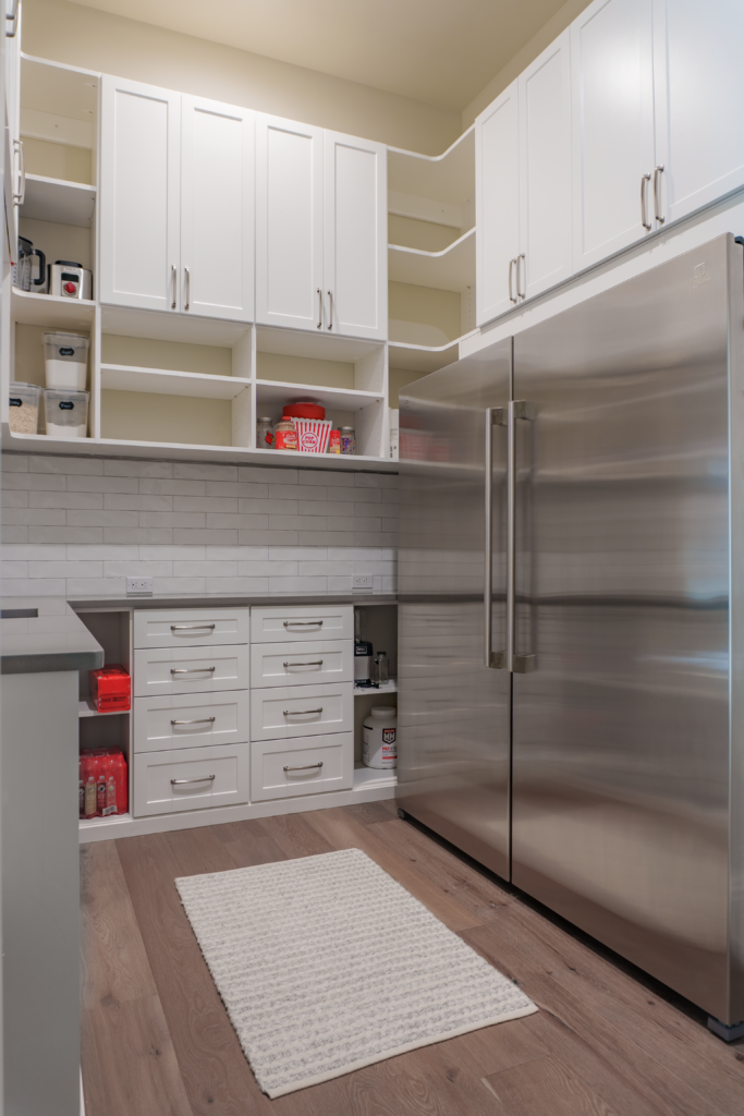 Photo of the pantry with a large fridge and freezer with plenty of counter space