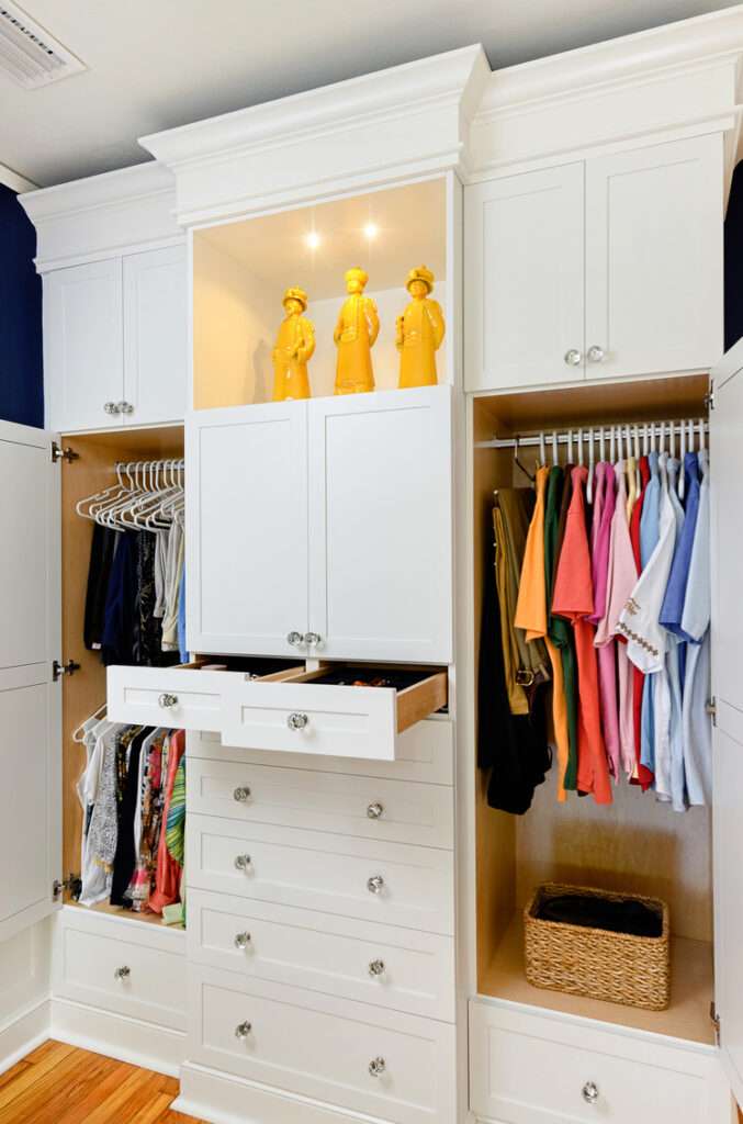 Master closet built-in opened up to show the handing clothes and jewelry trays